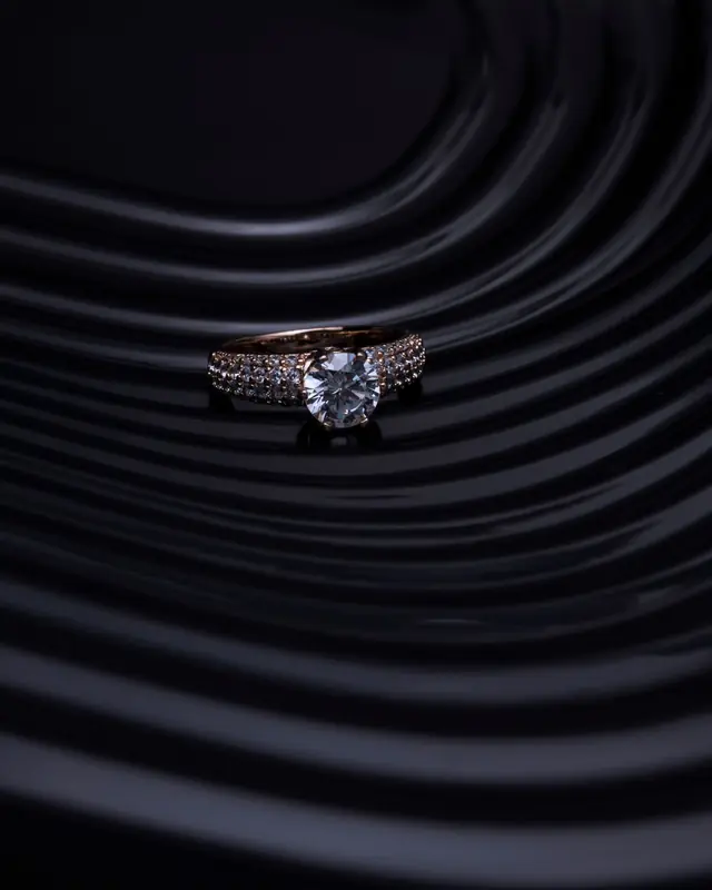 Solitaire diamond ring on dark ripples